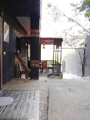an outside view of a building with a table and chairs at Petra Musa Rural House in Wadi Musa