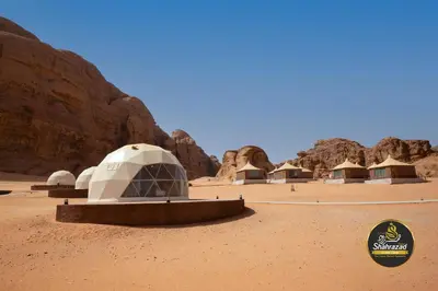 a group of domed buildings in the desert at Omsiat Shahrazad Luxury Camp in Wadi Rum