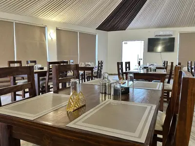 a dining room with a large table and chairs at Omsiat Shahrazad Luxury Camp in Wadi Rum