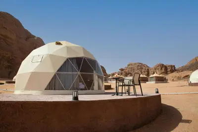 a dome tent in the middle of a desert at Omsiat Shahrazad Luxury Camp in Wadi Rum