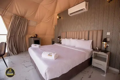 a bedroom with a large bed in a tent at Omsiat Shahrazad Luxury Camp in Wadi Rum