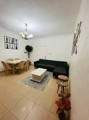 a living room with a couch and a table at Lovely 3 bedrooms rental unit in Aqaba