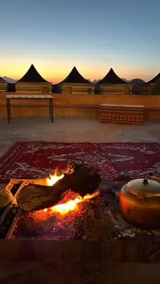 a fire pit in a courtyard with tents in the background at Wadi Rum Beyond nature in Wadi Rum