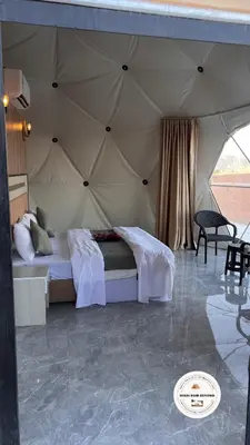 a bedroom with a bed in a tent at Wadi Rum Beyond nature in Wadi Rum