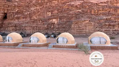 a group of four domes in front of a mountain at Wadi Rum Beyond nature in Wadi Rum
