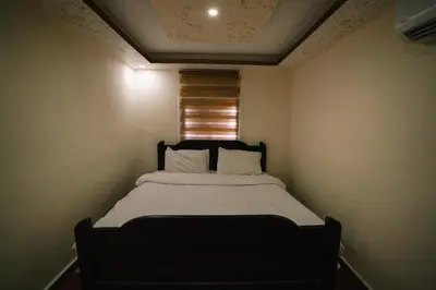 a bed in a small room with a window at Wadi Rum Desert Dunes Luxury Camp in Wadi Rum