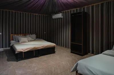 a bedroom with a bed and a purple ceiling at Wadi Rum Desert Dunes Luxury Camp in Wadi Rum