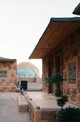an outside view of a building with a building at Wadi Rum Desert Dunes Luxury Camp in Wadi Rum