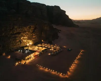 an aerial view of a wedding in the desert at night at Wadi Rum Desert Dunes Luxury Camp in Wadi Rum
