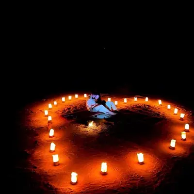 a group of candles in a circle with a woman at Charlotte luxury camp in Wadi Rum