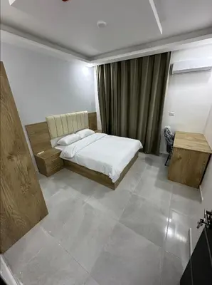 a bedroom with a bed and a couch and a table at رويال جروب اربد Royal Group Hotel in Irbid