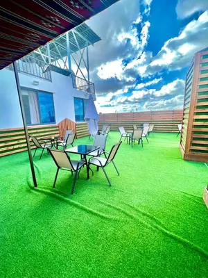 a group of chairs and tables on the roof of a building at رويال جروب اربد Royal Group Hotel in Irbid