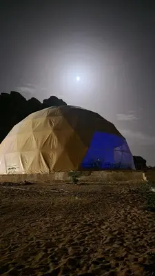 a large tent sitting on a sandy beach at MAXIMAS LUXURY Wadi Rum in Wadi Rum