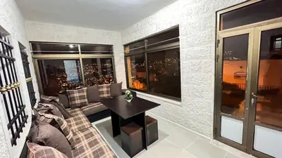 a living room with a couch and a table at Sara apartment in Wadi Musa