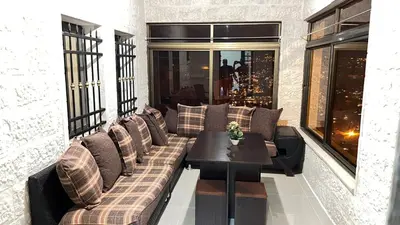 a living room with a couch and a table at Sara apartment in Wadi Musa