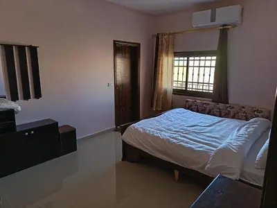 a bedroom with a bed and a window at Sara apartment in Wadi Musa