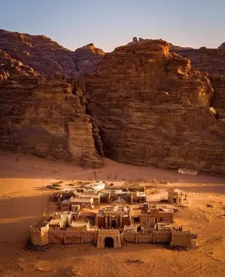 a village in the desert near a cliff at Tamim Luxury wadi rum camp in Wadi Rum