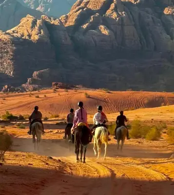 a group of people riding horses in the desert at SELEN RUM LUXURY CAMP & Jeep Tours in Wadi Rum