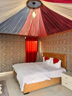 a bedroom with a bed with a red ceiling at Wadi Rum Time in Wadi Rum