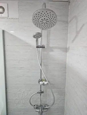 a shower with a shower head in a bathroom at Amazing Wadi Rum Camp in Wadi Rum