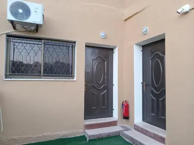 two black doors on the side of a building at EMILE ALTWAL Hotel in Madaba