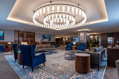 a lobby of a hotel with a large chandelier at Radisson Blu Hotel, Amman Galleria Mall in Amman