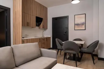 a living room with a couch and a table and chairs at Radisson Blu Hotel, Amman Galleria Mall in Amman