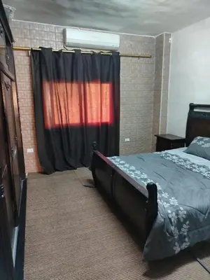 a bedroom with a bed in front of a window at شقة ام نوارة الحديثة modern nice flat in Amman