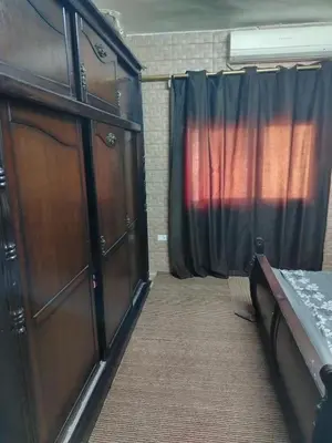 a bedroom with a bed and a dresser and a curtain at شقة ام نوارة الحديثة modern nice flat in Amman