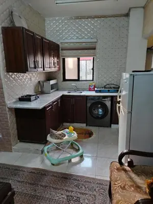 a kitchen with a sink and a refrigerator at شقة ام نوارة الحديثة modern nice flat in Amman