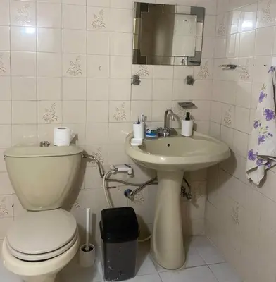 a bathroom with a toilet and a sink at Homey Apt. with beautiful view in Amman