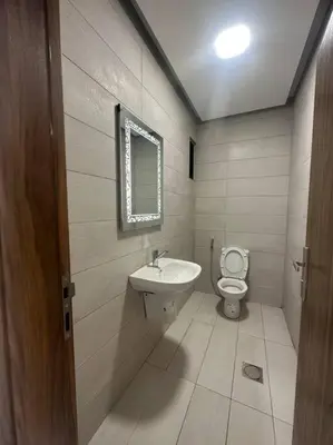 a bathroom with a sink and a toilet at cozy home near all services 20 in Rujm ash Sharāʼirah