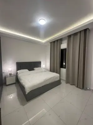 a bedroom with a large bed in a room at cozy home near all services (19) in Rujm ash Sharāʼirah