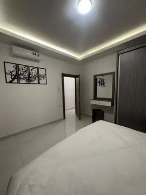 a bedroom with a large white bed in a room at cozy home near all services (19) in Rujm ash Sharāʼirah