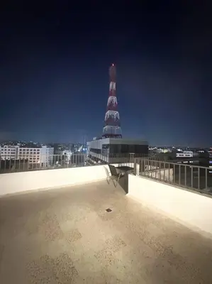 a view from the roof of a building with a lighthouse at cozy rooftop near al services 23 in Rujm ash Sharāʼirah