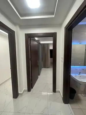 a bathroom with a sink and a toilet and a mirror at cozy rooftop near al services 23 in Rujm ash Sharāʼirah