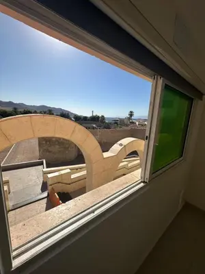 a window in a room with a view at Happy Beach Castel for Apartment قلعة شاطئ السعادة للشقق المفروشة in Aqaba