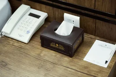 a telephone and a box on a table at Petra Bermudez Hotel in Wadi Musa