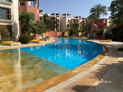 a swimming pool in the middle of a building at Talabay Top cosy 3 bedroom apartment in Aqaba