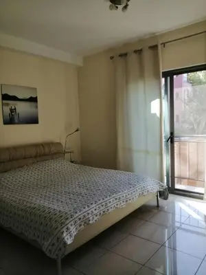 a bedroom with a bed and a large window at Talabay Top cosy 3 bedroom apartment in Aqaba