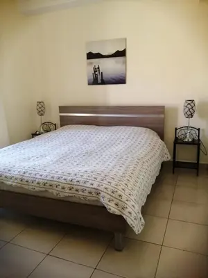 a bedroom with a large bed with a white comforter at Talabay Top cosy 3 bedroom apartment in Aqaba