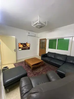 a living room with a couch and a table at شقه مفروشه مميزه in Irbid