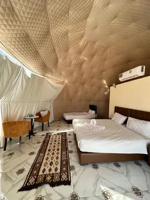 a bedroom with a bed in a tent at Wadi rum camp in Wadi Rum