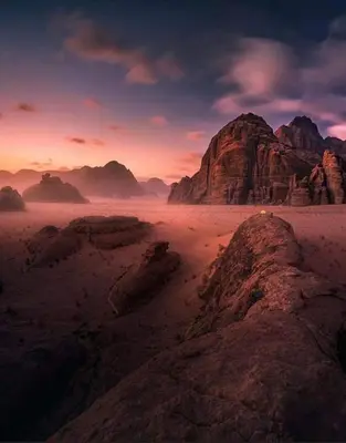 a view of a desert with rocks and mountains at Wadi rum camp in Wadi Rum