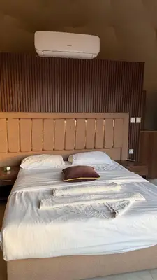 a bedroom with a large bed with a light above it at Madonna Rum camp bubbles & Jeep tours in Wadi Rum