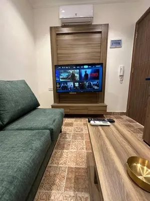 a living room with a couch and a flat screen tv at 3/ Antica jabalal-lwebdeh in Amman