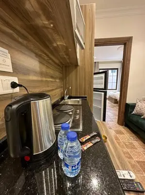a kitchen with two bottles of water on a counter at 3/ Antica jabalal-lwebdeh in Amman