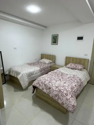 a room with two beds in a room at Karak Plaza Residences in Kerak
