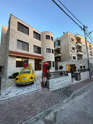 a yellow car parked in front of a building at 6/ Antica jabalal-lwebdeh in Amman