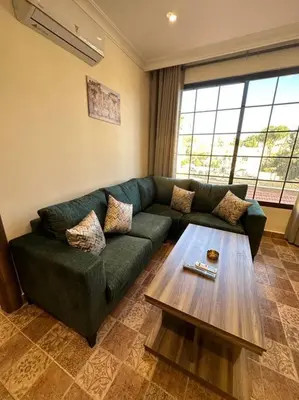 a living room with a green couch and a coffee table at 8/ Antica jabalal-lwebdeh in Amman